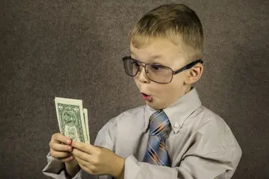 Boy examines dollars